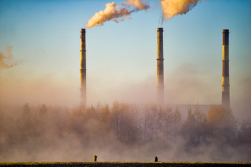 Factory pipes against the sky in winter