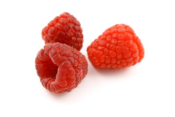 fresh red raspberry fruits isolated on a white background