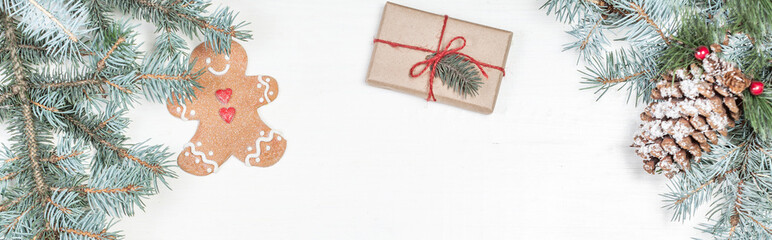 Christmas gifts, fir tree branches, xmas holiday decorations, festive symbols on white wooden background with copyspace. Christmas composition..