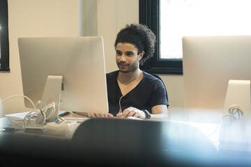 Young man using desktop computer