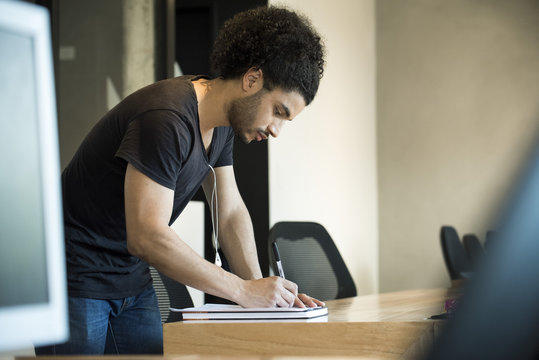 Young man writing
