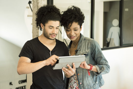 Couple using digital tablet together