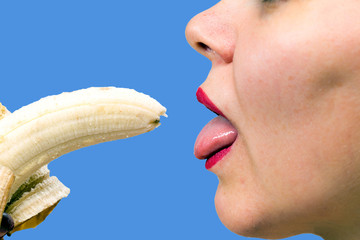 Young woman eating a banana
