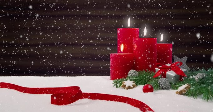 Fourth Sunday of Advent - Beautiful snowfall in front of a Christmas decoration arrangement on a snowy table in front of a wooden background - ProRes