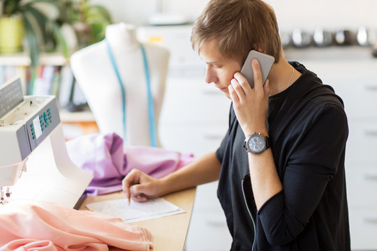 fashion designer calling on smartphone at studio