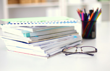 close up of stack of papers on white background