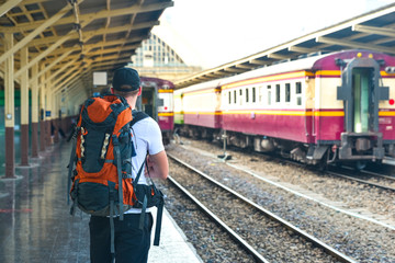 Man with backpack is waiting for a train in Thailand © steph photographies