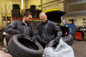 Fototapeta na wymiar auto mechanics changing car tires at workshop