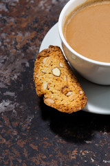 cup of coffee with milk and Italian cookies cantucci, vertical top view