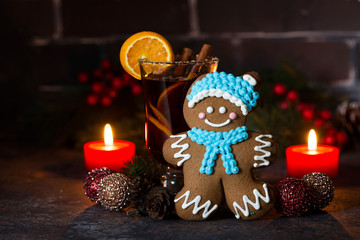 Christmas composition with mulled wine and gingerbread man on dark background