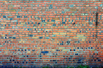 old brick wall as background or texture red sometimes scaly cracked paint