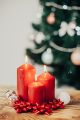 Red candles on background of a Christmas tree 