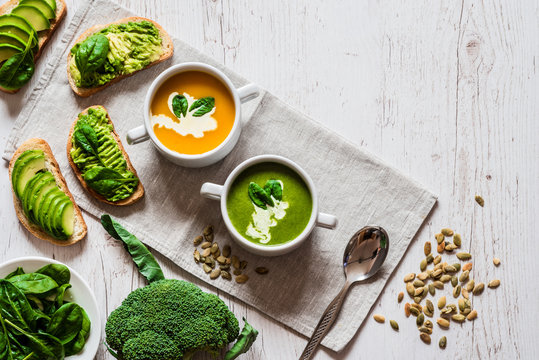 Vegetarian healthy food. Soup and vegan sandwiches. Different sandwiches with avocado. Brunch on white wooden background