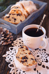 Stollen, traditional Christmas cake and cup of coffee. Toned image