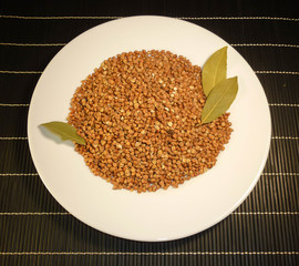 buckwheat in a white plate on a dark background