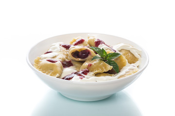 Homemade sweet dumplings with berries and sour cream