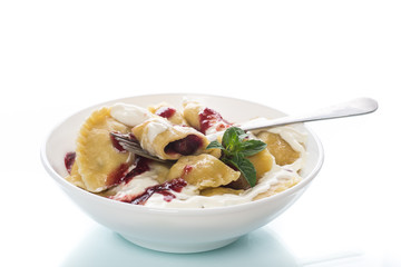 Homemade sweet dumplings with berries and sour cream