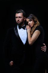 fashion studio photo of beautiful couple in elegant clothes