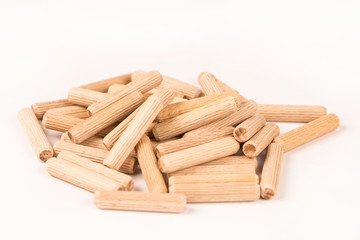 Pile of wooden dowels isolated on white background