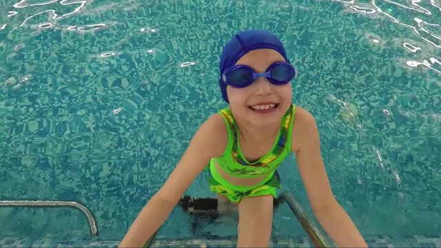 Swimmer schoolgirl in swimming pool portrait