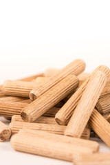Pile of wooden dowels isolated on white background