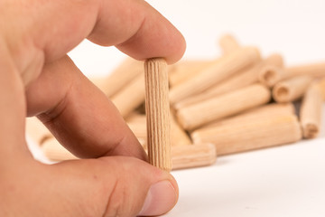 Pile of wooden dowels isolated on white background
