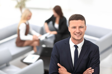 young businessman on blurred background office.