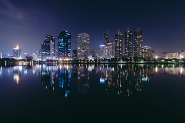 Fototapeta na wymiar light from modern building bright light in night city with skyline. peaceful and gorgeous night cityscape concept.