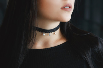 Close up of stylish black choker on female neck