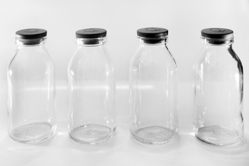Four Clear Glass Milk Bottle Close Up