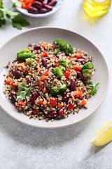 Quinoa salad with broccoli, red beans, paprika and greenery. Super food and healthy eating concept. Overhead view. Copy space 
