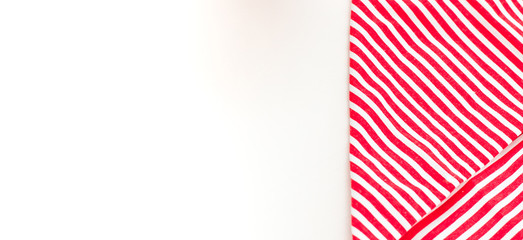 Fototapeta premium Red textile, napkin, tablecloth on wooden kitchen table. View from above, top with copy space. Traditional pattern and color.