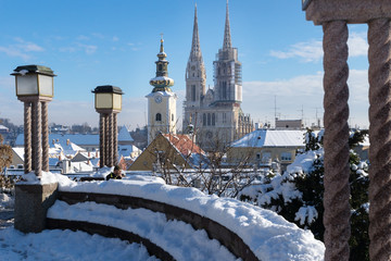 View over Zagreb during winter with snow with view to towers of church and cathedral and seating...