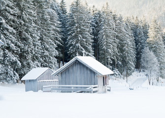 wood hut in winter snow landscape