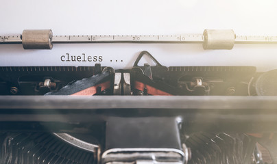 clueless written on vintage manual typewriter