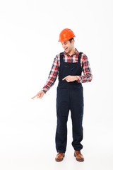 Full length portrait of a smiling young male builder