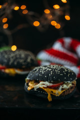 Black burger on table. Christmas concept for fast food
