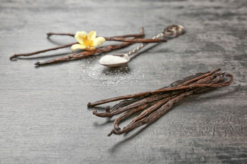 Dried vanilla pods on grey background