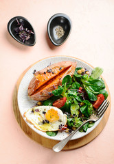 Sweet potato with salad and fried egg