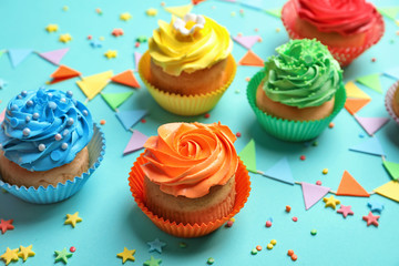 Tasty cupcakes on color background