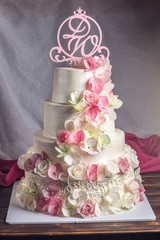 Beautiful home wedding four-tiered cake decorated with pink and green fondant handmade