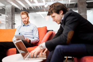 Business people looking at their devices