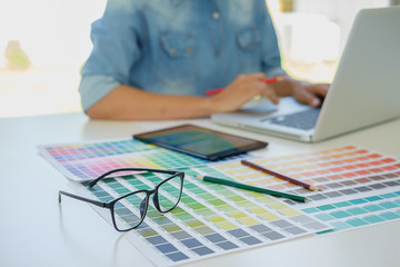 Graphic design and color swatches and pens on a desk. Architectural drawing with work tools and accessories