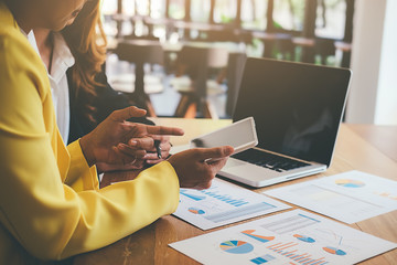 Business concept. Business people discussing the charts and graphs showing the results of their successful teamwork.