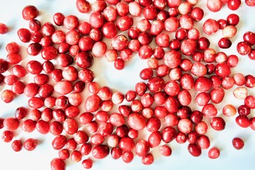 A lot of tasty and healthy red cranberries on the white background