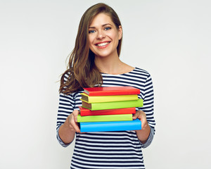 Beautiful girl holding pile of books.