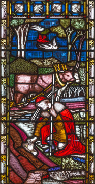 LONDON, GREAT BRITAIN - SEPTEMBER 19, 2017: The Parable of the Hidden Treasure on the stained glass in St Mary Abbot's church on Kensington High Street.