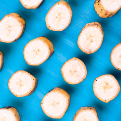 Sliced banana pattern on blue background horizontal