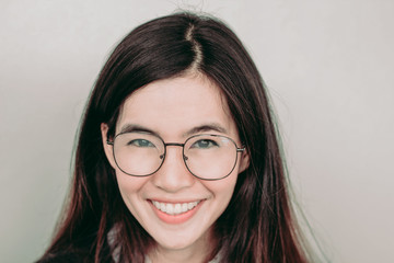 Head shot of Young cute asian student wearing glasses and smiling
