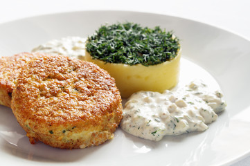 pike cutlets with tartar sauce and potato tower decorated with dill